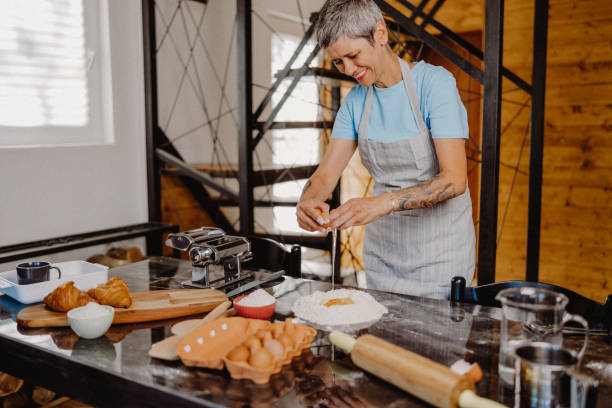 istock Woman making homemade pasta 1607819274