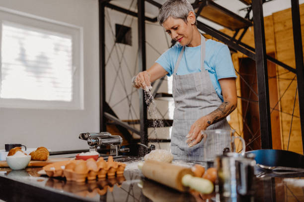 istock Woman making homemade pasta 1607825717