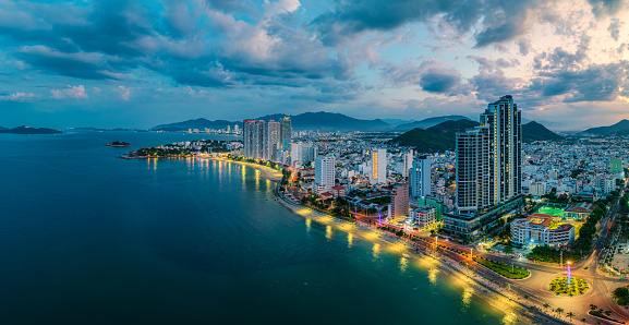Drone view panorama Nha Trang city from the sea in sunset, Khanh Hoa province, central Vietnam