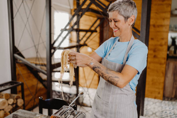 istock Woman making homemade pasta 1607832560
