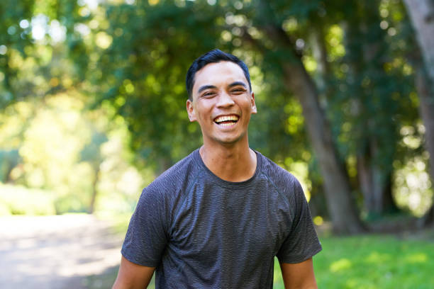 istock Attractive Asian man laughing on trail run, walking in nature beautiful scenery 1607834232