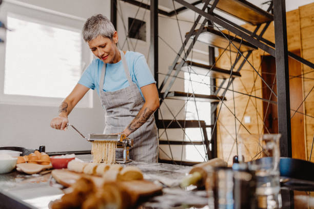 istock Woman making homemade pasta 1607834421