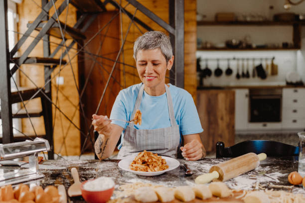 istock Woman making homemade pasta 1607838421
