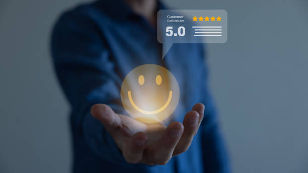 istock Businessman holding virtual smiley face with five stars and using computer laptop for online evaluation product and service , customer satisfaction concept. 1607841697