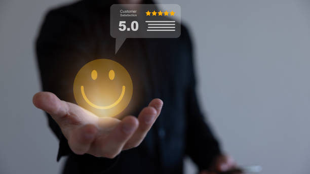 istock Businessman holding virtual smiley face with five stars and using computer laptop for online evaluation product and service , customer satisfaction concept. 1607841730