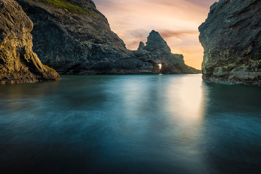 Long exposure rocky beach at sunset near Pistol River Beach near Gold Beach, Oregon.