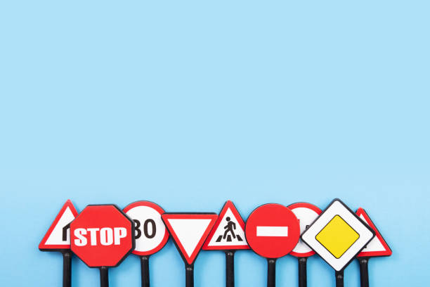 road signs on a blue background, driving education and training, traffic law, traffic regulations - driving training car safety imagens e fotografias de stock