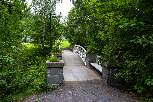 City park and wooden pedestrian bridge in the city of Imatra Finland.