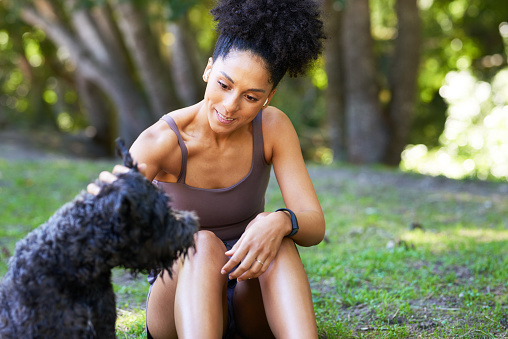 Woman and her pet dog enjoy time outdoors in the park, companionship. High quality photo
