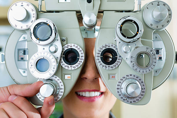 istock Young woman at phoropter for eye test 160786096