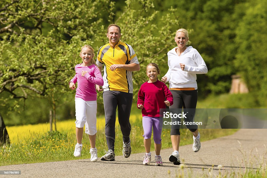 Family jogging for sport outdoors Family jogging for sport outdoors with the kids on summer day Family Stock Photo