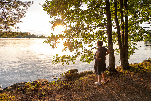 A woman enjoys nature and silence at Lake Saimaa in Finland