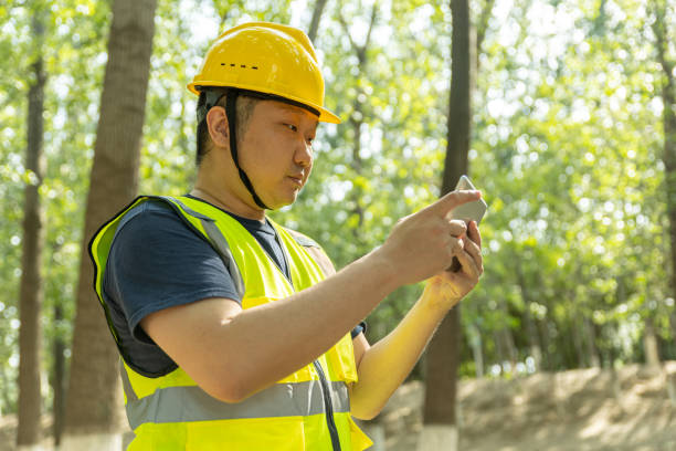 istock male engineer wering a helmet and safety vest taking note on tablet 1607914667