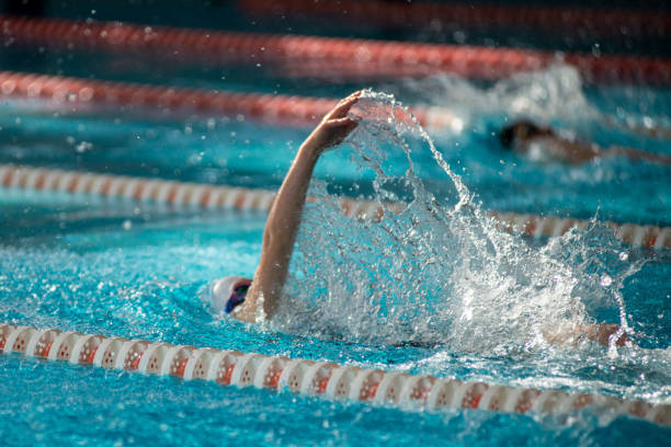istock Swimmer swims backstroke swimming style in the pool 1607953490