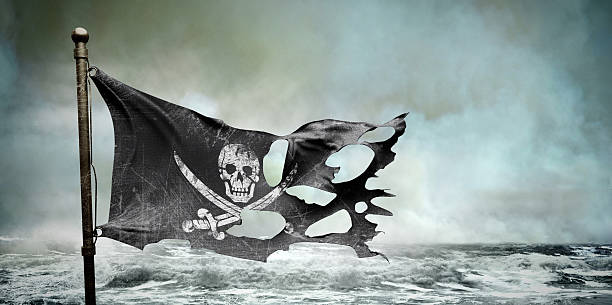 ripped torn flag ripped torn pirate flag shredded photos stock pictures, royalty-free photos & images