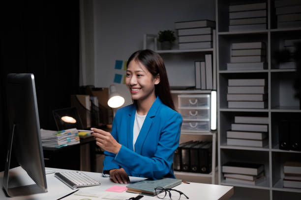 istock Asian businesswoman working inside the office at night 1607973748