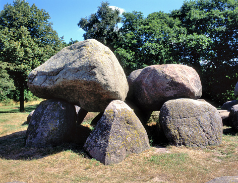 A dolmen or Hunebed in Dutch is a type of single-chamber megalithic tomb, usually consisting of two or more vertical megaliths supporting a large flat horizontal capstone or table.
