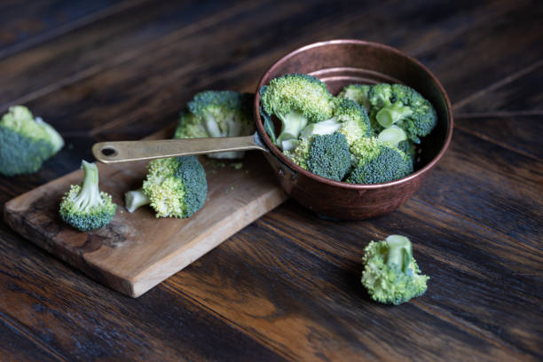 istock Broccoli cabage cutted on wooden board and put to vintage colander 1608006512