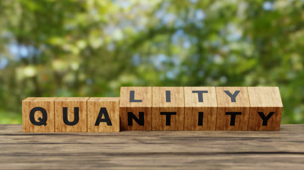 istock Quality over quantity. 3D Wooden cubes changes the word 'quantity' to 'quality' on wooden table, copy space. Business and quality over quantity concept.3d illustration 1608029321