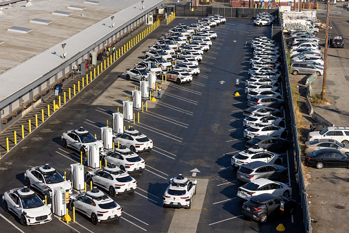 San Francisco, CA, USA - August 6, 2023:  Aerial view of Alphabet's Waymo self-driving car fleet storage facility in the Bayview Hunter's Point district just before the California Public Utilities Commission is set to vote  to allow Waymo and Cruise the ability to charge fares in San Francisco for complete driverless rides in the City.