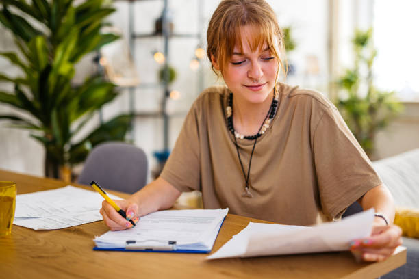 istock Young Woman Checking Her Finances At Home 1608040825