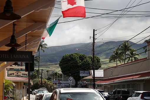 On April 14 2023 this is the view from from street looking down a side street looking at the mountains in the distance.  Many businesses line the streets of Lahaina Maui.