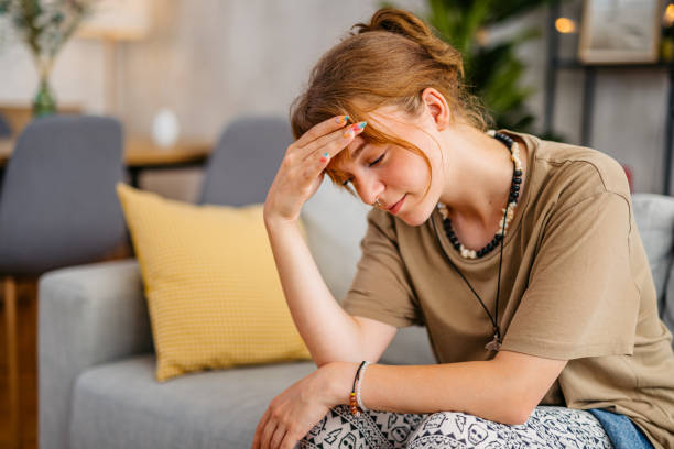 istock Sad Woman Sitting Alone On The Sofa In Her Apartment 1608041197