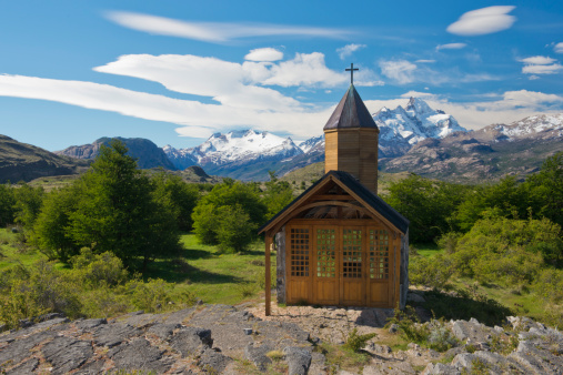 small single church of village with meadow and field