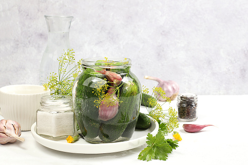 Cucumbers, dill, garlic, currant leaves, cherry, horseradish, oak and basil, rustic pickling recipe, Cucumbers and ingredients for pickling them, home canning concept, healthy and natural food.selective focus