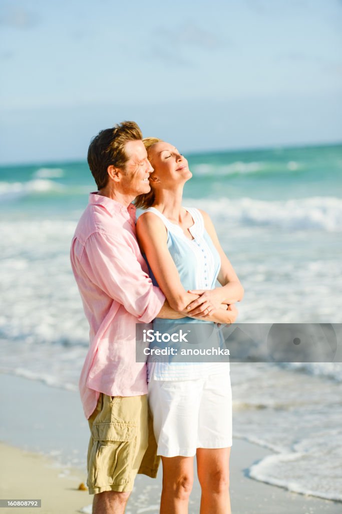 Beautiful Happy Mature Enjoying Sunny Day on the Beach Adult Stock Photo