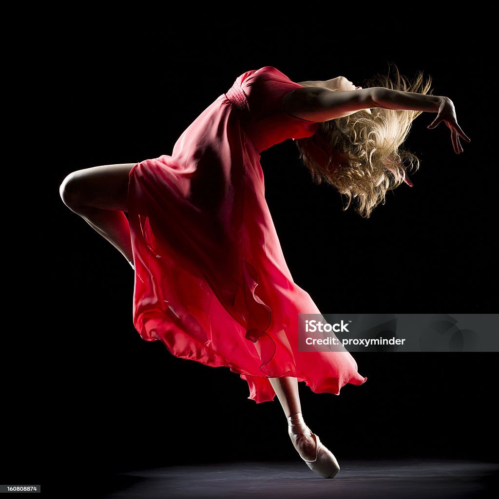 The Dancer on black background Ballerina in red dress  dancing on black background Dancing Stock Photo