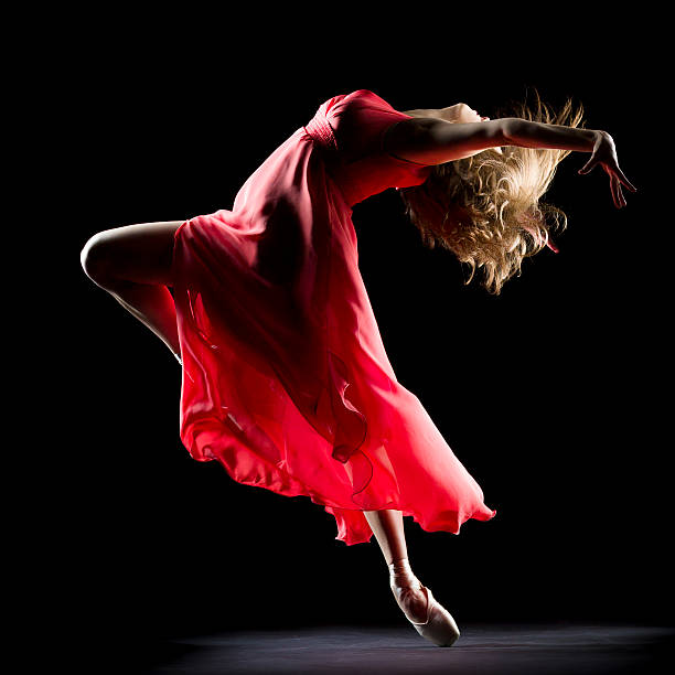 The Dancer on black background Ballerina in red dress  dancing on black background red dress photos stock pictures, royalty-free photos & images