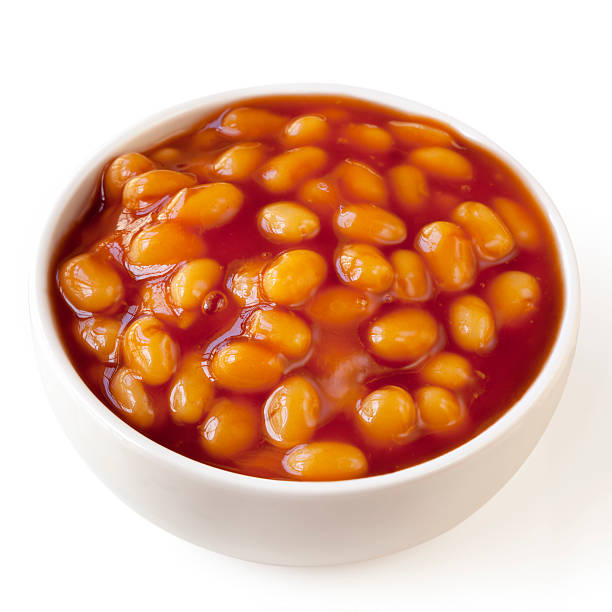 Baked Beans Isolated Baked beans in a white bowl, isolated on white background. baked beans stock pictures, royalty-free photos & images