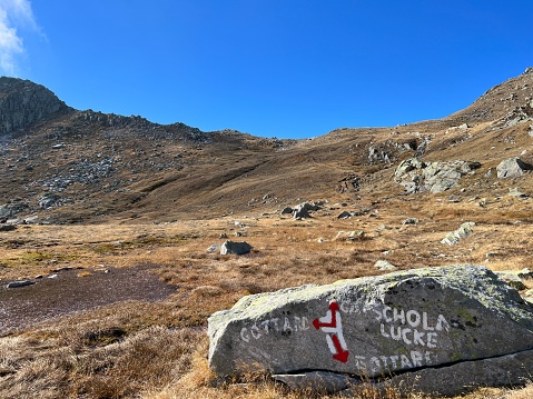 Mountaineering signposts and markings in the mountainous area of the alpine St. Gotthard Pass (Gotthardpass) and the massif of the Swiss Alps, Airolo - Canton of Ticino (Tessin), Switzerland (Schweiz)