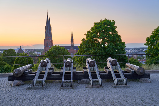 Uppsala, Sweden. Old Cannons in front of the Castle with Uppsala Cathedral on background