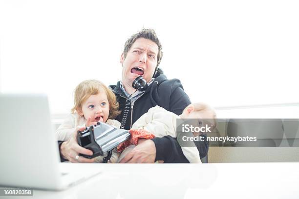 Humorous Dad In Office Trying To Multitask Work And Parenting Stock Photo - Download Image Now