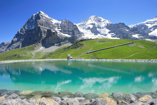 Eiger, Monch and Jungfrau in the Bernese Alps reflecting in a reservoir at Kleine Scheidegg, Switzerland