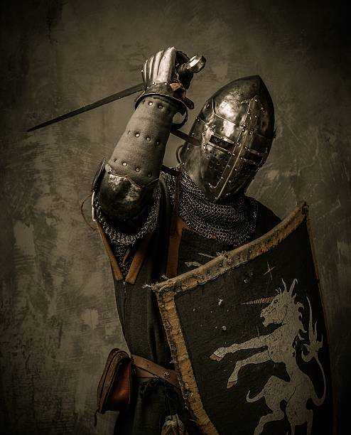 A knight holding a shield and sword stock photo