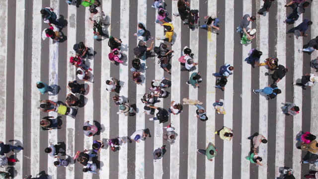 Aerial view of pedestrians walking across