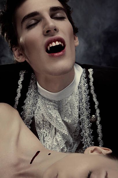 Vampire Angry vampire biting a woman. Halloween theme. male vampire biting his victim stock pictures, royalty-free photos & images