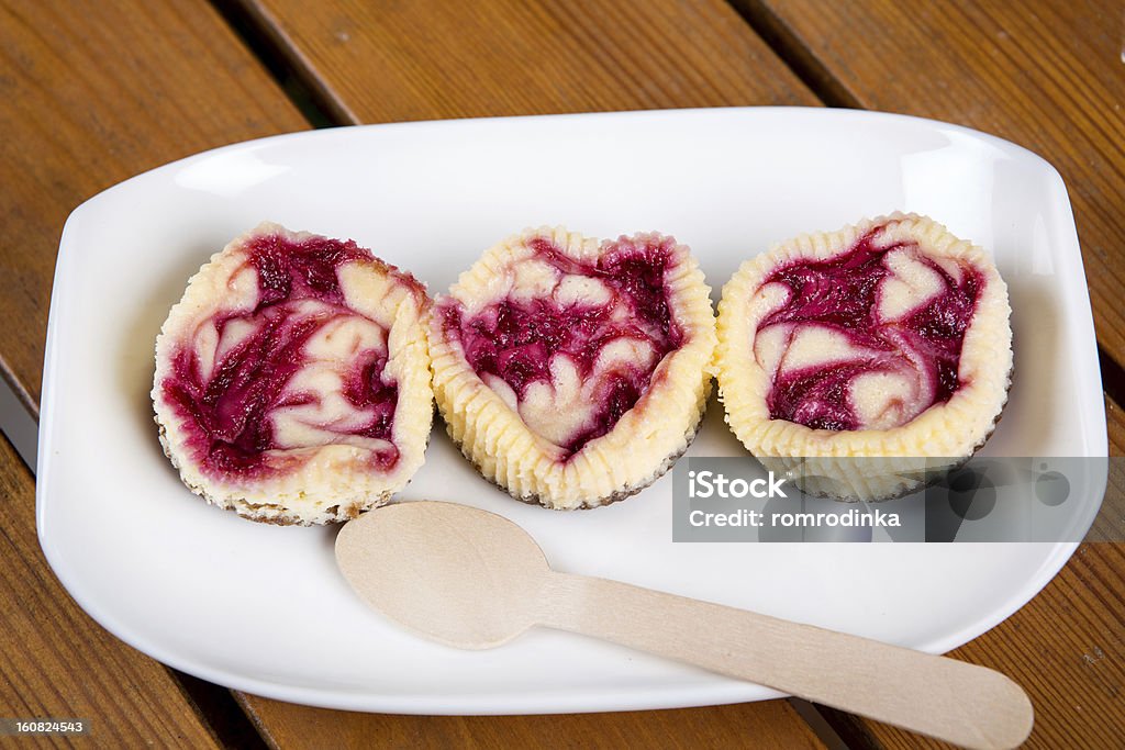 Mini raspberry cheesecakes in muffin forms Fresh baked mini raspberry cheesecakes in muffin forms Cheesecake Stock Photo