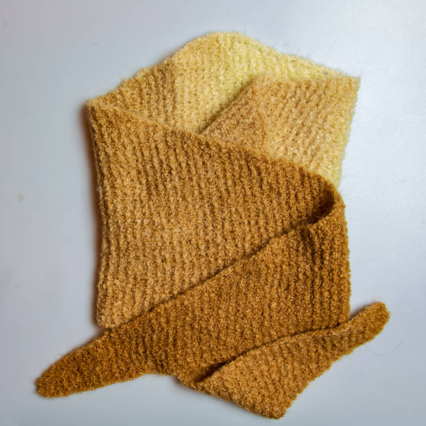 istock Knitted wool textile with background texture in light beige creamy brown shade. Beige color gradient on texture background. Scarf. 1608247198
