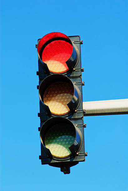 istock Red traffic light against a bright blue sky 160825335