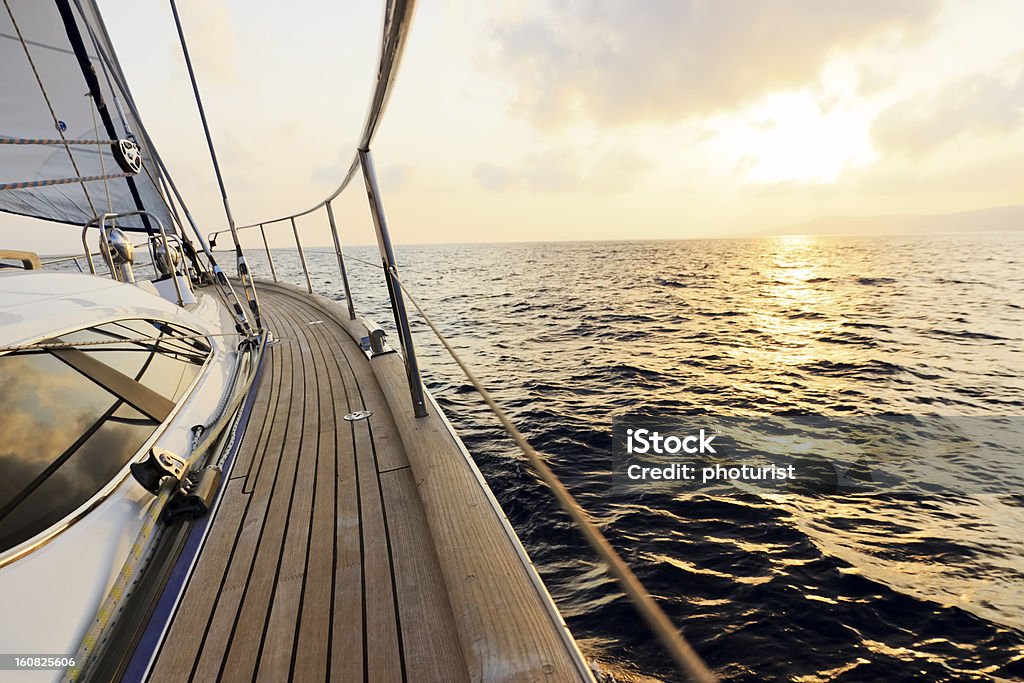 Luxury yacht sailing at sunset Boat Deck Stock Photo