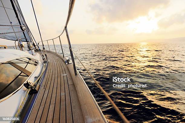 Luxury Yacht Sailing At Sunset Stock Photo - Download Image Now - Boat Deck, Rudder, Yacht