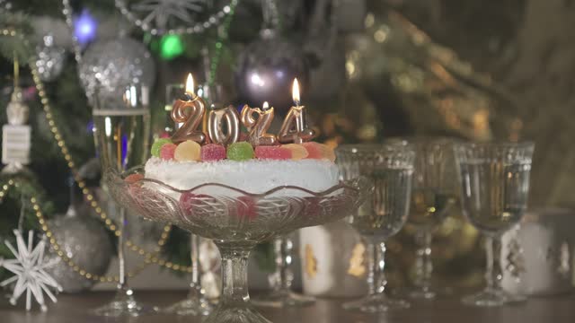 Christmas cake decorated with burning candles Happy New Year 2024