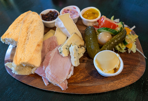 Authentic English pub served meal of a cheese and ham Ploughman's Lunch
