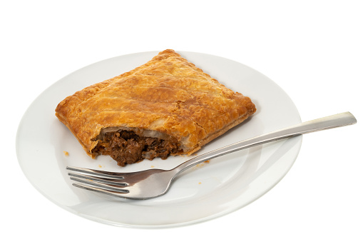 A meat pie on a plate - white background