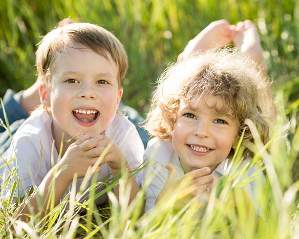 istock Happy children lying on grass 160831151