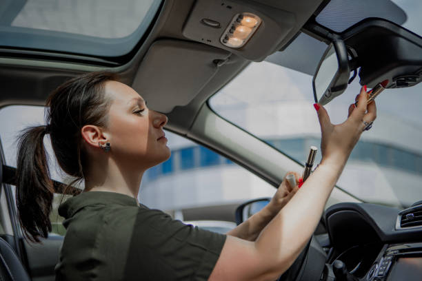 istock Irresponsible distracted female driver at the wheel 1608314635